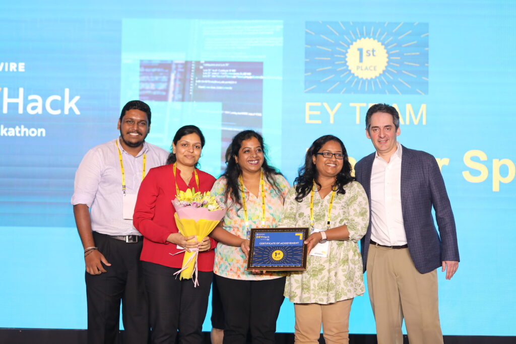 Group picture of the first place winner team, Hacker Space from EY holding up their first place award