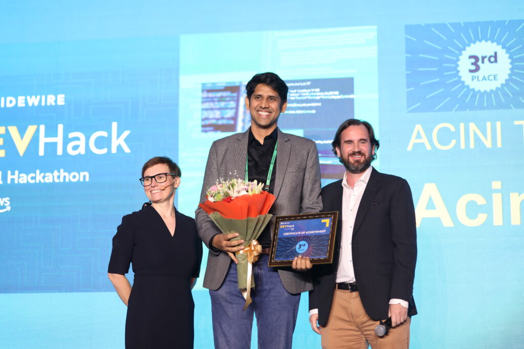 Picture of the Guidewire Alliance Manager for Europe, accepting the Third Place Winner award on behalf of Team Acinivoyage from Acini